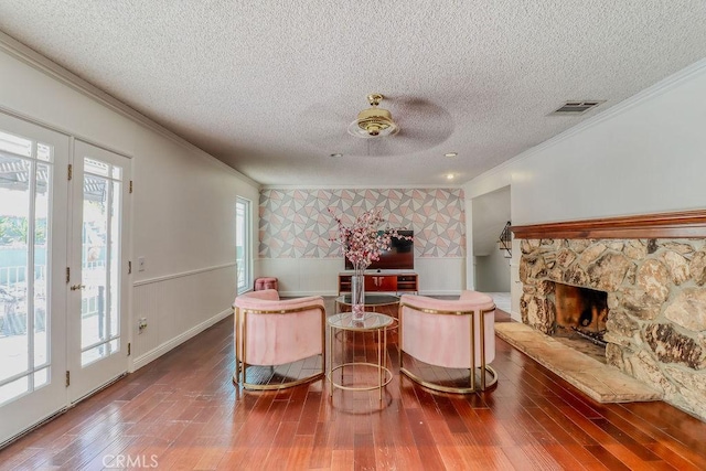 1169 Lyndhurst Dr, Riverside, CA 92507 - living room with crown molding, a textured ceiling, wood finished floors, a wainscoted wall, and a fireplace