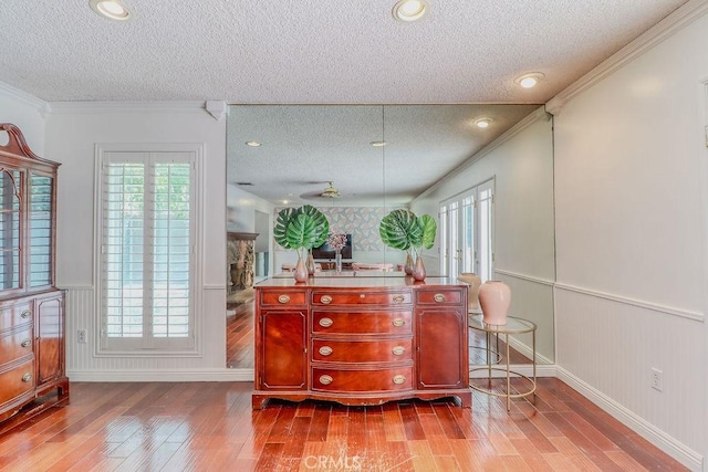 1169 Lyndhurst Dr, Riverside, CA 92507 - interior space featuring a textured ceiling, hardwood / wood-style flooring, baseboards, crown molding, and reddish brown cabinets