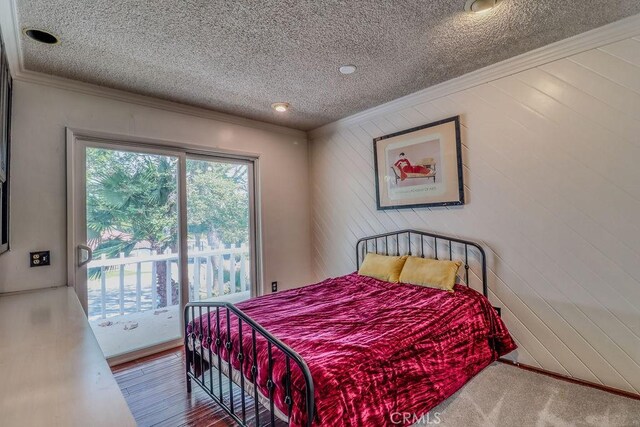 1169 Lyndhurst Dr, Riverside, CA 92507 - bedroom featuring crown molding, a textured ceiling, access to outside, and wood walls