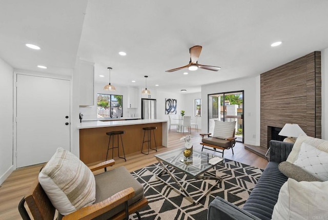 1915 Via Las Palmas Unit 32A, National City, CA 91950 - living area with healthy amount of natural light, recessed lighting, light wood finished floors, ceiling fan, and a fireplace