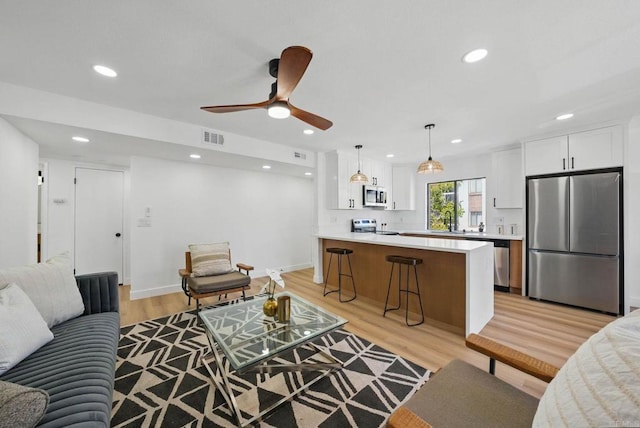 1915 Via Las Palmas Unit 32A, National City, CA 91950 - living room with light wood-style flooring, recessed lighting, a ceiling fan, and baseboards