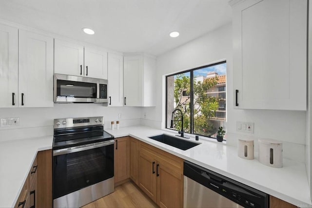 1915 Via Las Palmas Unit 32A, National City, CA 91950 - kitchen featuring appliances with stainless steel finishes, a sink, light countertops, white cabinets, and recessed lighting