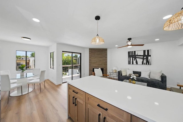 1915 Via Las Palmas Unit 32A, National City, CA 91950 - kitchen featuring light wood-type flooring, decorative light fixtures, recessed lighting, light countertops, and open floor plan