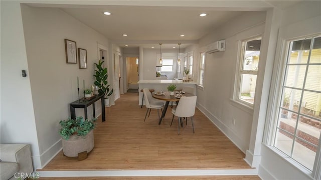 1520 Ohio Ave, Long Beach, CA 90804 - dining space featuring light wood finished floors, a wall unit AC, baseboards, and recessed lighting