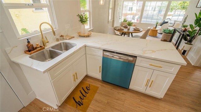 1520 Ohio Ave, Long Beach, CA 90804 - kitchen featuring dishwashing machine, a sink, light wood-style flooring, and white cabinetry