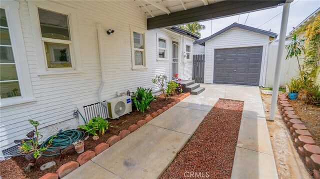 1520 Ohio Ave, Long Beach, CA 90804 - doorway to property featuring ac unit, a detached garage, and driveway