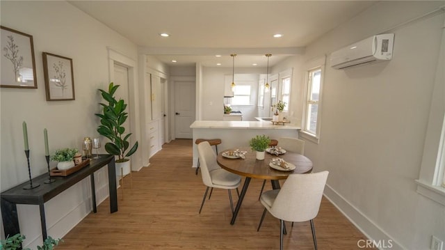 1520 Ohio Ave, Long Beach, CA 90804 - dining area featuring an AC wall unit, recessed lighting, wood finished floors, and baseboards