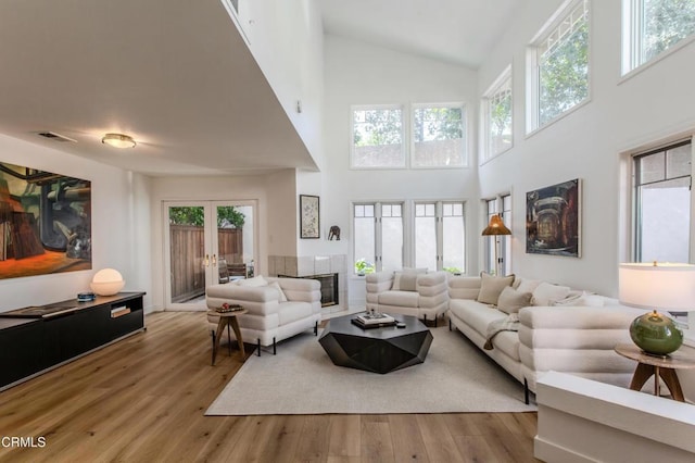 2759 Butter Creek Dr, Pasadena, CA 91107 - living area with french doors, high vaulted ceiling, wood finished floors, and a fireplace