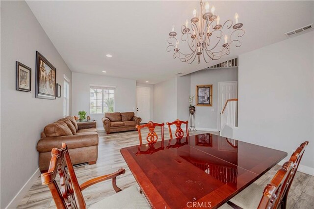 6524 Moonriver St, Eastvale, CA 91752 - dining room with light wood finished floors, baseboards, stairs, a chandelier, and recessed lighting