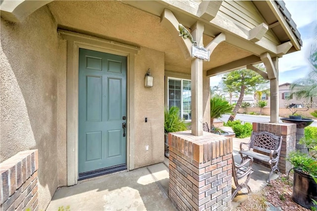 6524 Moonriver St, Eastvale, CA 91752 - doorway to property featuring covered porch and stucco siding