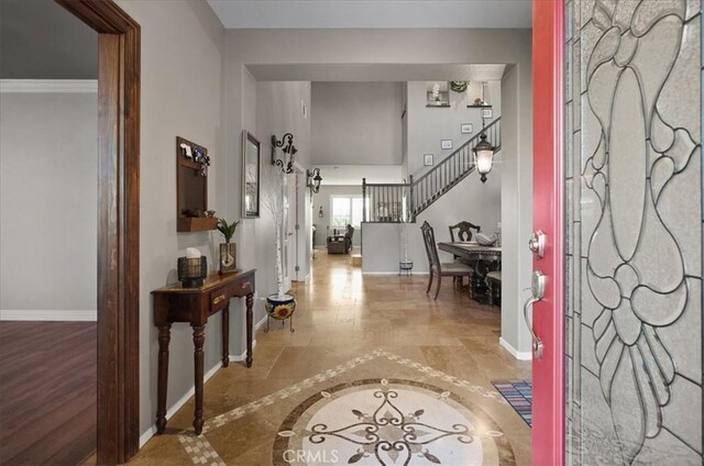 23501 Brigin Pl, Murrieta, CA 92562 - foyer entrance featuring inlaid floor details, baseboards, and stairway