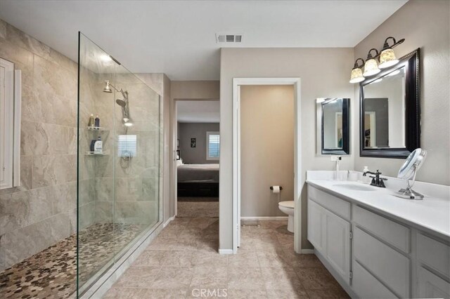 23501 Brigin Pl, Murrieta, CA 92562 - ensuite bathroom featuring toilet, a walk in shower, vanity, tile patterned flooring, and baseboards