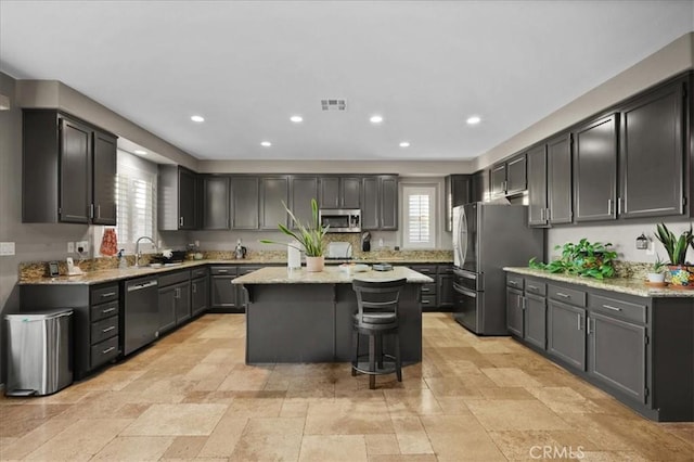 23501 Brigin Pl, Murrieta, CA 92562 - kitchen with stainless steel appliances, a sink, healthy amount of natural light, a kitchen island, and recessed lighting
