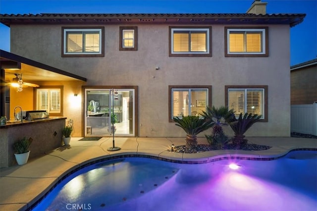 23501 Brigin Pl, Murrieta, CA 92562 - back of property with an outdoor kitchen, stucco siding, an outdoor pool, a patio area, and a chimney