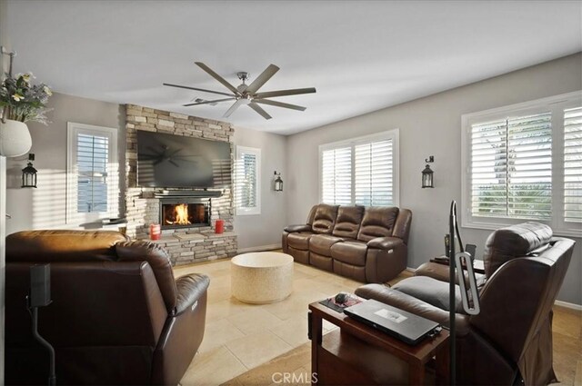 23501 Brigin Pl, Murrieta, CA 92562 - tiled living room featuring ceiling fan, a fireplace, and baseboards