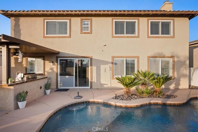 23501 Brigin Pl, Murrieta, CA 92562 - back of property with area for grilling, stucco siding, an outdoor pool, a patio, and a chimney