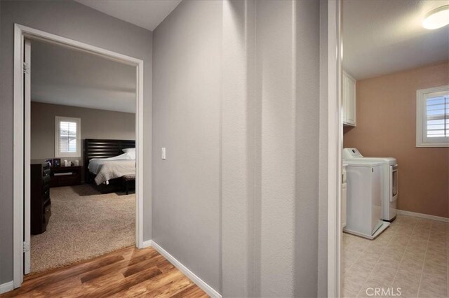 23501 Brigin Pl, Murrieta, CA 92562 - hall with washer and clothes dryer, healthy amount of natural light, and baseboards