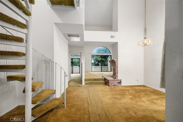 17202 Corbina Ln Unit 206, Huntington Beach, CA 92649 - carpeted entrance foyer featuring a high ceiling, stairway, and baseboards