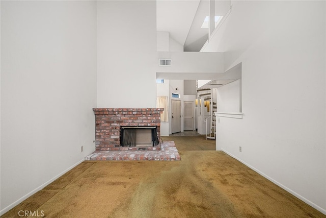 17202 Corbina Ln Unit 206, Huntington Beach, CA 92649 - unfurnished living room featuring carpet floors, high vaulted ceiling, and a fireplace