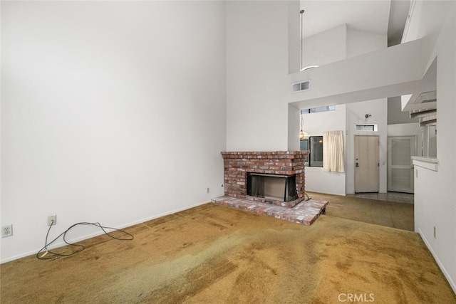 17202 Corbina Ln Unit 206, Huntington Beach, CA 92649 - unfurnished living room with carpet floors, a brick fireplace, baseboards, and a high ceiling