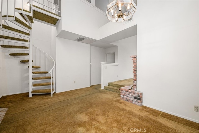 17202 Corbina Ln Unit 206, Huntington Beach, CA 92649 - unfurnished living room with stairway, carpet flooring, a chandelier, and a high ceiling