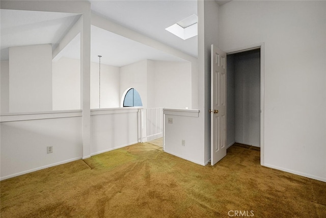 17202 Corbina Ln Unit 206, Huntington Beach, CA 92649 - empty room featuring a skylight, carpet, and baseboards