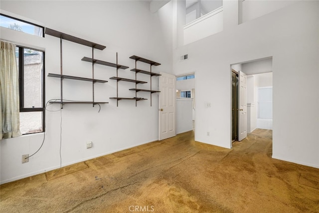 17202 Corbina Ln Unit 206, Huntington Beach, CA 92649 - spare room with carpet flooring, baseboards, and a towering ceiling