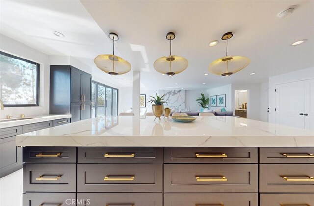 4263 E Ranch Gate Rd, Anaheim Hills, CA 92807 - kitchen featuring light stone counters, recessed lighting, pendant lighting, open floor plan, and a kitchen island