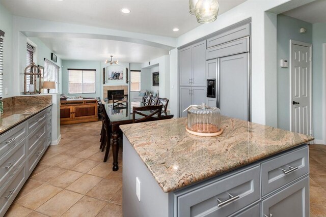 1749 Skimmer Ct, Carlsbad, CA 92011 - kitchen with gray cabinets, paneled built in fridge, light stone countertops, a center island, and recessed lighting