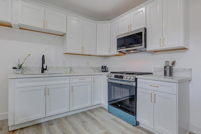 1320 Vinca Way, San Diego, CA 92114 - kitchen with appliances with stainless steel finishes, a sink, white cabinets, and light wood-type flooring