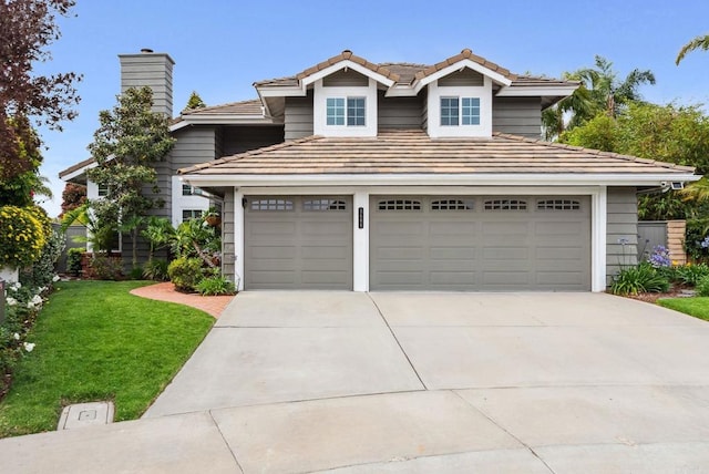 3686 Landfair Ct, San Diego, CA 92130 - view of front facade featuring driveway, a chimney, a front lawn, a tiled roof, and an attached garage