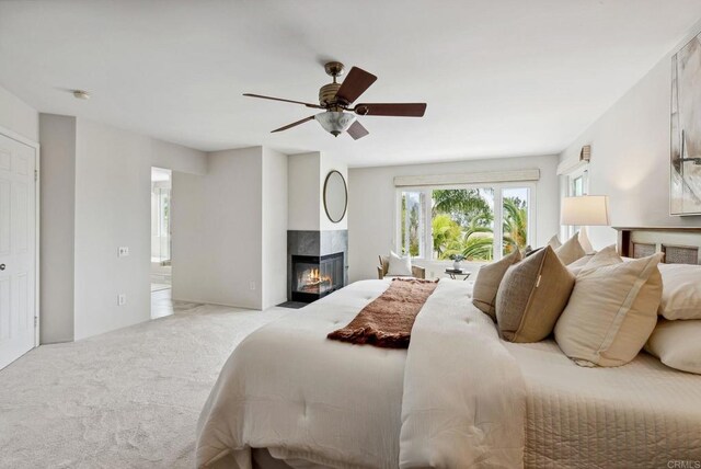 3686 Landfair Ct, San Diego, CA 92130 - carpeted bedroom with a high end fireplace and a ceiling fan