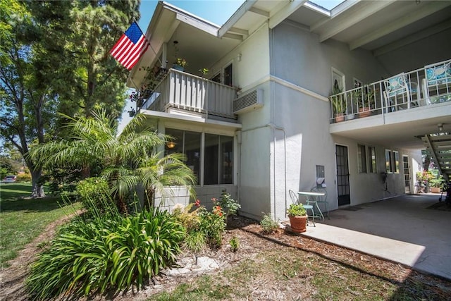 270 Avenida Sevilla Unit C, Laguna Woods, CA 92637 - view of home's exterior with a balcony and stucco siding