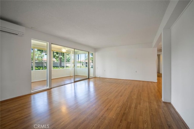270 Avenida Sevilla Unit C, Laguna Woods, CA 92637 - spare room featuring a wall mounted AC and wood finished floors