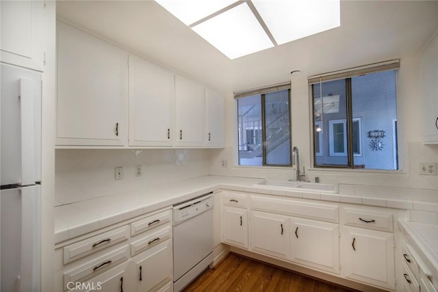 270 Avenida Sevilla Unit C, Laguna Woods, CA 92637 - kitchen featuring dishwasher, a sink, tile countertops, white cabinets, and fridge