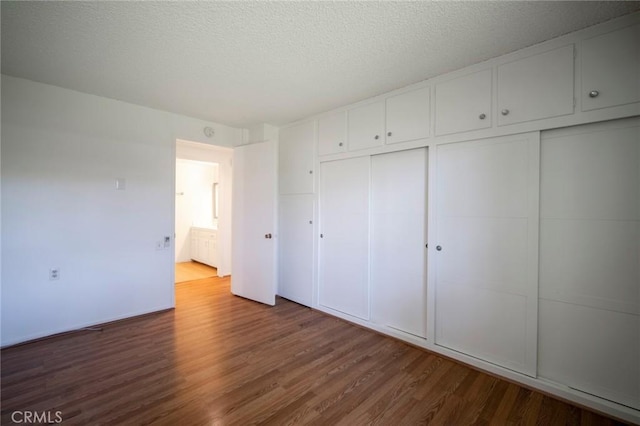 270 Avenida Sevilla Unit C, Laguna Woods, CA 92637 - unfurnished bedroom featuring wood finished floors and a textured ceiling