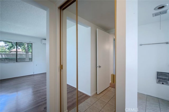 270 Avenida Sevilla Unit C, Laguna Woods, CA 92637 - hall with a wall mounted air conditioner, light wood-style flooring, and heating unit