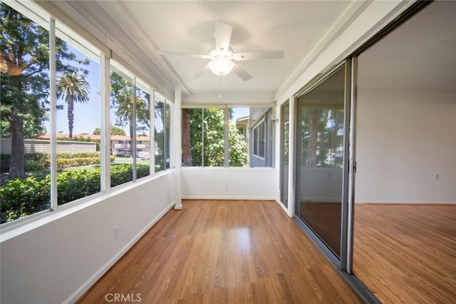 270 Avenida Sevilla Unit C, Laguna Woods, CA 92637 - unfurnished sunroom with wood finished floors, baseboards, and a textured ceiling
