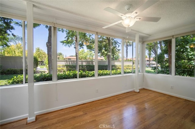 270 Avenida Sevilla Unit C, Laguna Woods, CA 92637 - unfurnished sunroom featuring healthy amount of natural light, wood finished floors, baseboards, and a textured ceiling