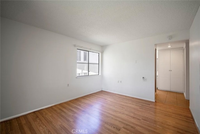 270 Avenida Sevilla Unit C, Laguna Woods, CA 92637 - spare room with wood finished floors, a textured ceiling, baseboards, and a smoke detector