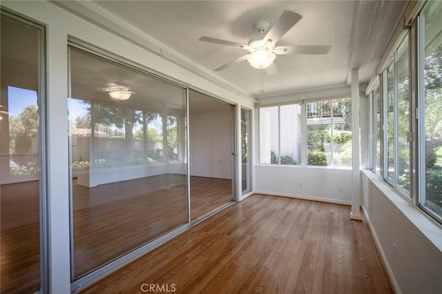 270 Avenida Sevilla Unit C, Laguna Woods, CA 92637 - unfurnished sunroom with a textured ceiling, ceiling fan, wood finished floors, and baseboards