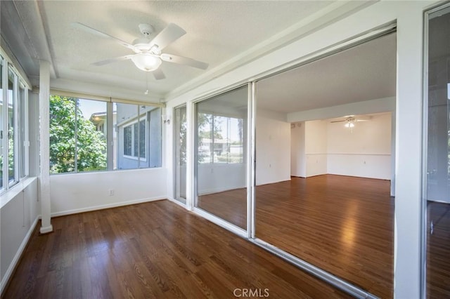 270 Avenida Sevilla Unit C, Laguna Woods, CA 92637 - unfurnished sunroom with wood finished floors, a textured ceiling, and baseboards