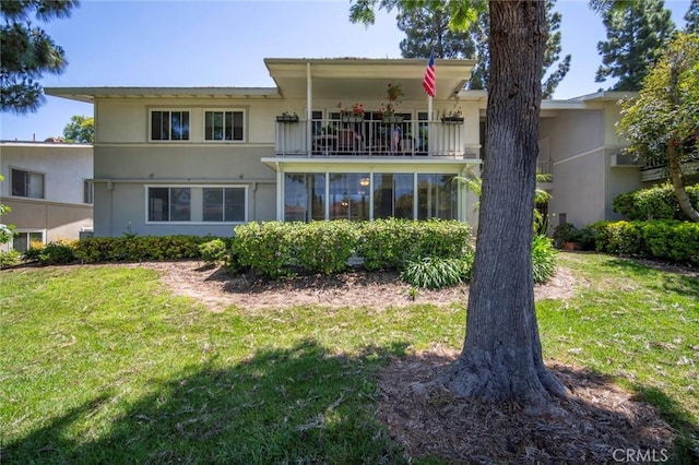 270 Avenida Sevilla Unit C, Laguna Woods, CA 92637 - back of property with a balcony, stucco siding, and a yard