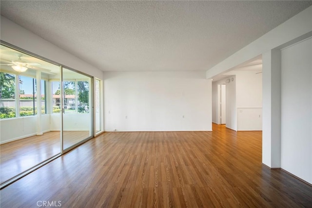 270 Avenida Sevilla Unit C, Laguna Woods, CA 92637 - unfurnished room with wood finished floors, a textured ceiling, and a ceiling fan