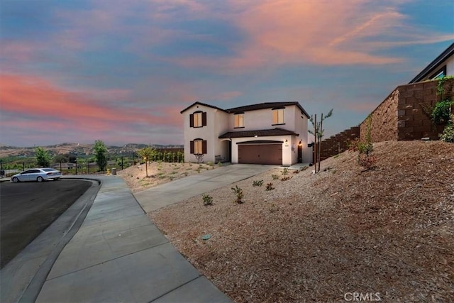 11653 Couples Ct, Beaumont, CA 92223 - view of front of house with driveway, a garage, and stucco siding