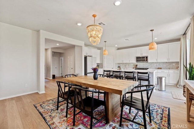 11653 Couples Ct, Beaumont, CA 92223 - dining area with light wood finished floors, recessed lighting, a chandelier, and baseboards