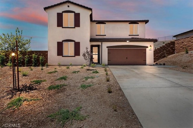 11653 Couples Ct, Beaumont, CA 92223 - mediterranean / spanish home featuring concrete driveway, stucco siding, a tiled roof, and an attached garage