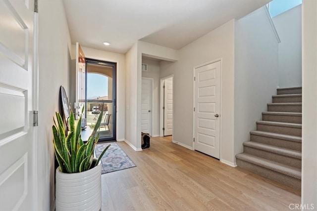 11653 Couples Ct, Beaumont, CA 92223 - foyer entrance featuring light wood-style flooring, stairs, baseboards, and recessed lighting