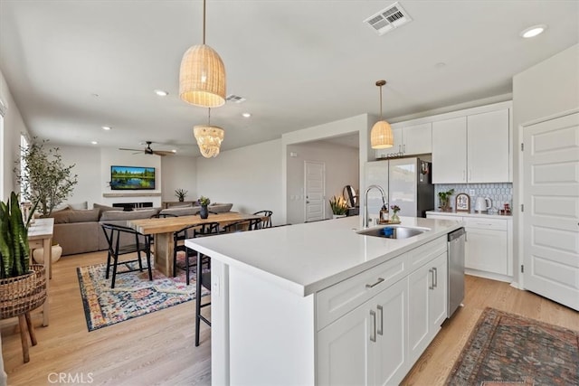 11653 Couples Ct, Beaumont, CA 92223 - kitchen featuring a sink, ceiling fan, freestanding refrigerator, light wood-style flooring, and decorative backsplash