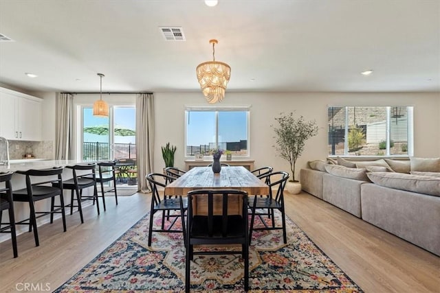 11653 Couples Ct, Beaumont, CA 92223 - dining area with healthy amount of natural light, light wood-style flooring, recessed lighting, and a chandelier